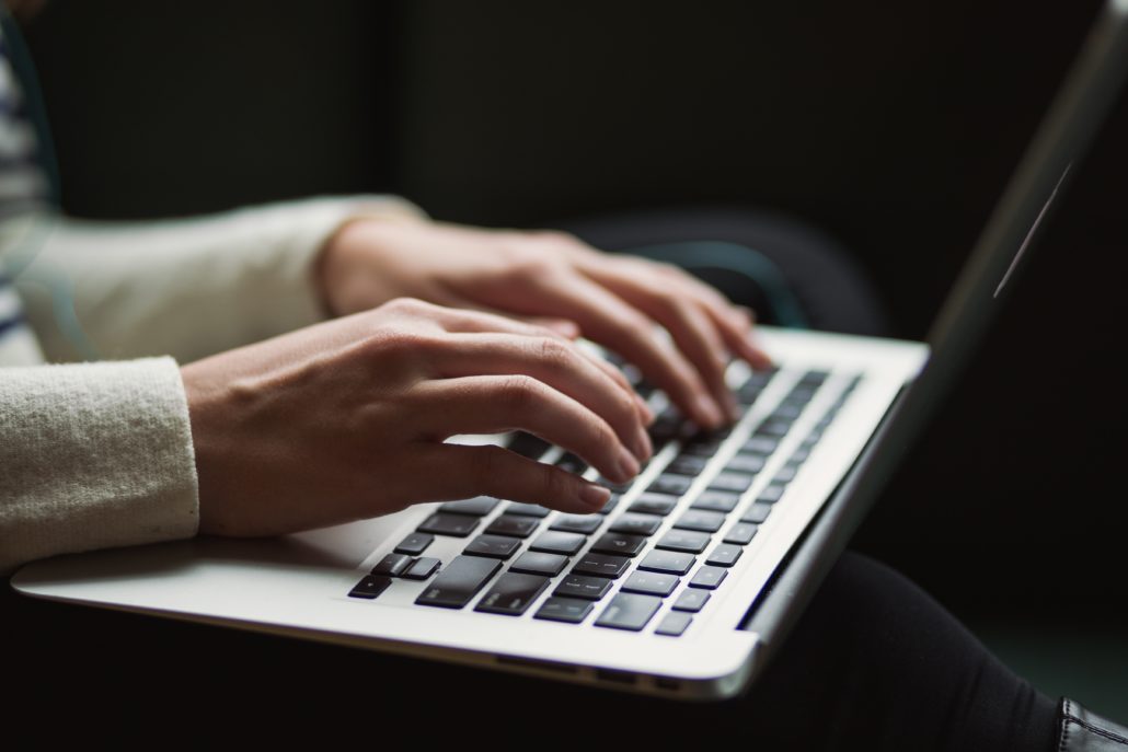 laptop with hands typing