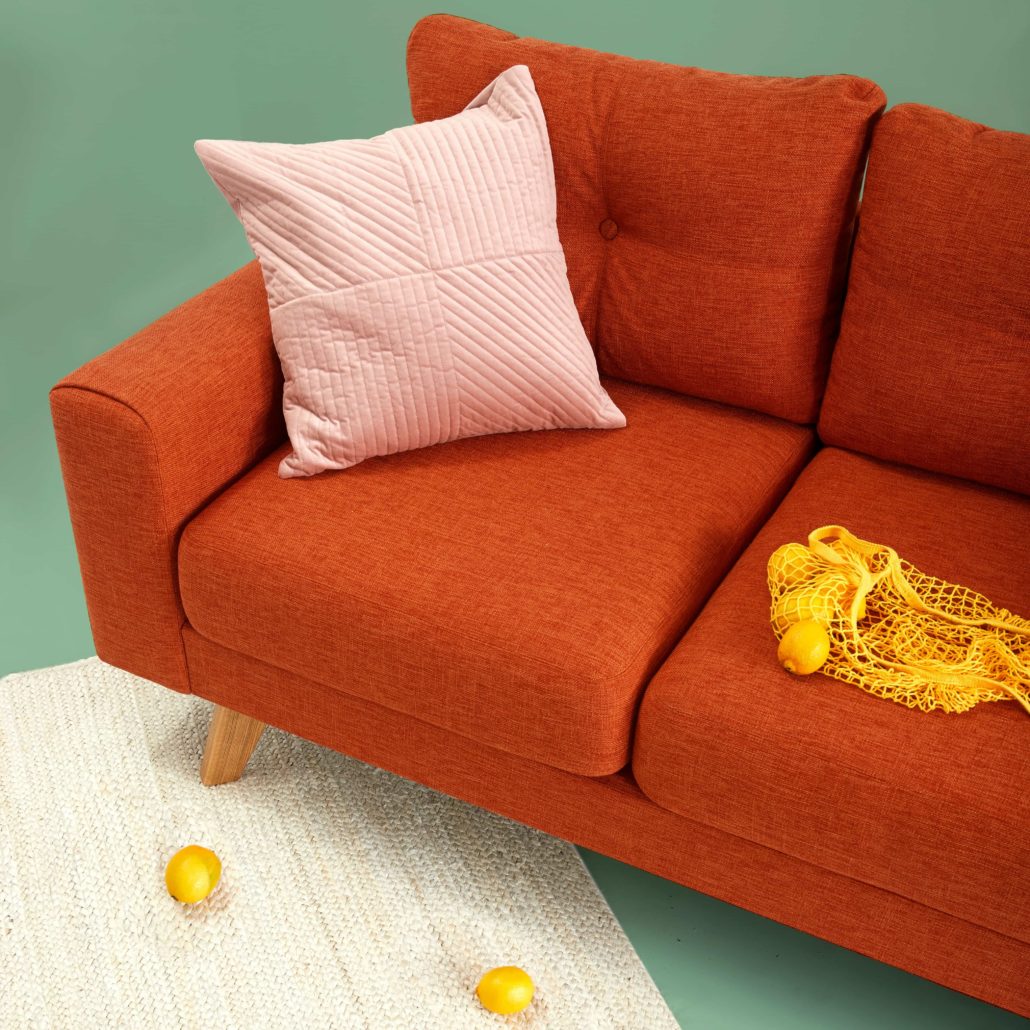 image of a red sofa with a pink cushion