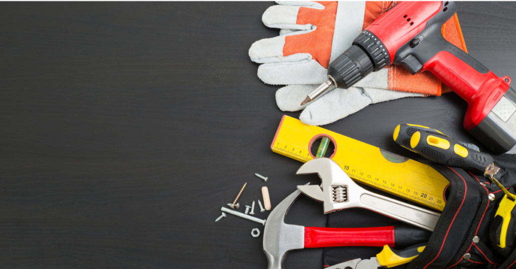 image of tools and a power drill and safety gloves