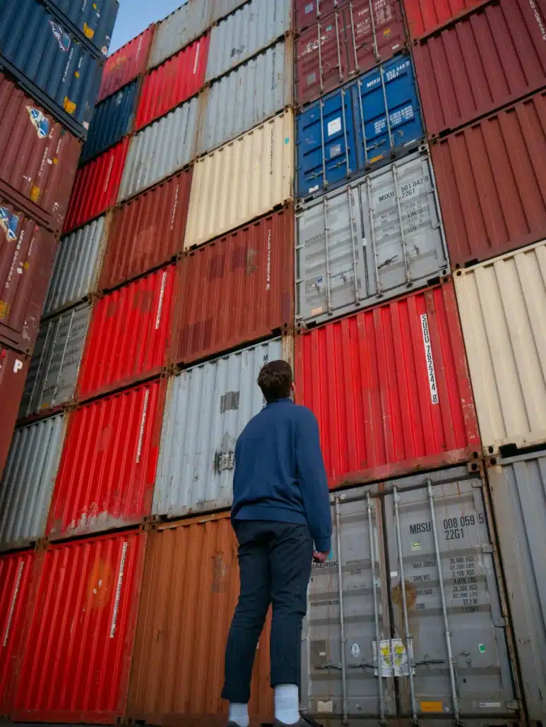 image of a man looking up at stacked containers